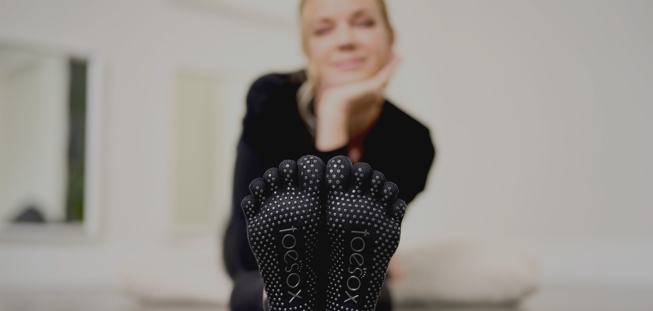 Woman wearing ToeSox grip socks
