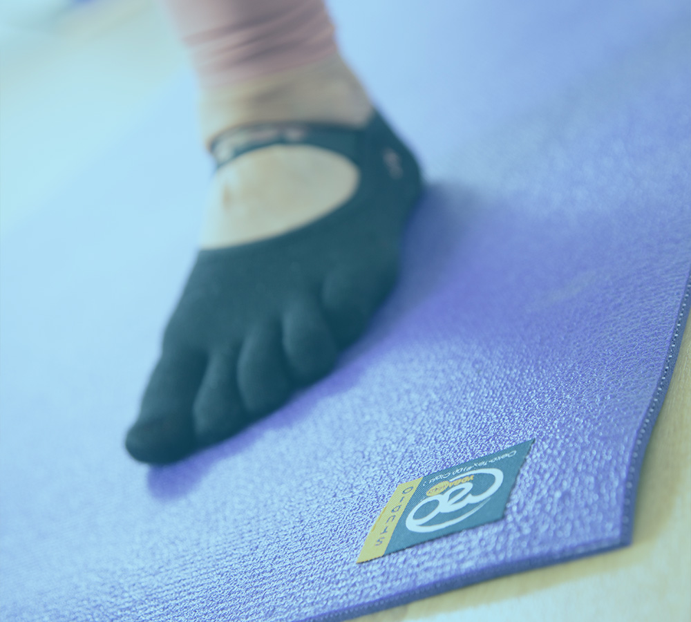 Yoga teacher on a studio yoga mat