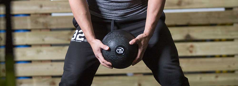 Fitness trainer using a slam ball